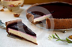 Homemade chocolate cream tart with blackberry jelly and walnuts
