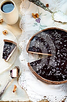 Homemade chocolate cream tart with blackberry jelly and walnuts