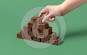 Homemade chocolate fudge. Woman hand grabbing a piece of fudge