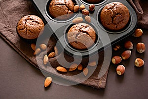 Homemade chocolate muffins brownies with cinnamon, almonds and hazelnuts