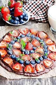 Homemade chocolate natural fruit pizza with berries