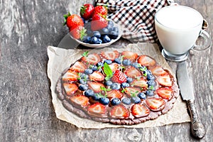 Homemade chocolate natural fruit pizza with berries