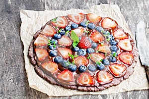 Homemade chocolate natural fruit pizza with berries