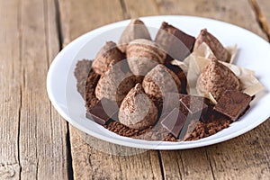 Homemade Chocolate Truffles With Cocoa Powder on a White Plate Old Wooden Background Tasty Candy Horizontal