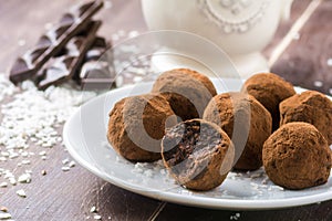 Homemade chocolate truffles with coconut flakes photo