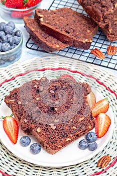 Homemade chocolate zucchini or courgette bread with pecan nuts, vertical