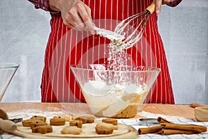 Homemade Christmas cookies, bakery man preparing gingerbread cookies dough, mixing ingredient together in the bowl by using whisk