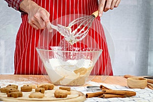 Homemade Christmas cookies, bakery man preparing gingerbread cookies dough, mixing ingredient together in the bowl by using whisk