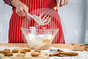 Homemade Christmas cookies, bakery man preparing gingerbread cookies dough, mixing ingredient together in the bowl by using whisk