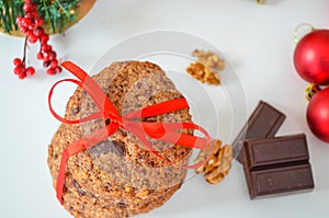 Homemade Christmas cookies with chocolate tied with red ribbon. Holiday decorations, ornaments. Christmas gifts