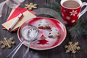 Homemade Christmas cookies in the shape of a Christmas tree, sprinkled with powdered sugar