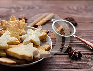 Homemade Christmas cookies and spices on wooden background