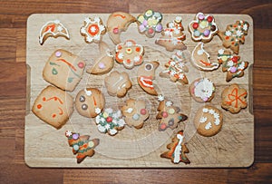 Homemade Christmas cookies on a wooden board top view.