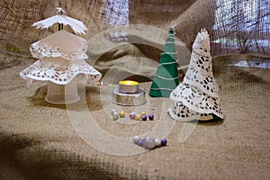 Homemade Christmas Decorations In Retro Style Stand Against The Background Made Of Burlap.