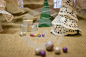 Homemade Christmas Decorations In Retro Style Stand Against The Background Made Of Burlap.