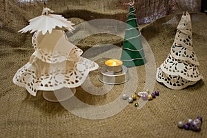 Homemade Christmas Decorations In Retro Style Stand Against The Background Made Of Burlap.