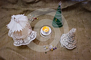 Homemade Christmas Decorations In Retro Style Stand Against The Background Made Of Burlap.