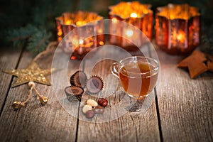 Homemade Christmas mulled wine punch with gingerbread, nuts and sweets on wooden rustic table.