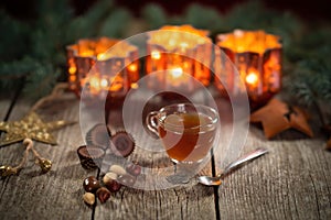 Homemade Christmas mulled wine punch with gingerbread, nuts and sweets on wooden rustic table.