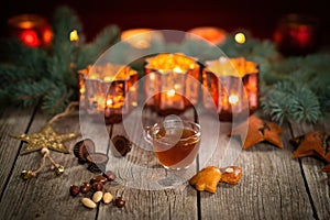 Homemade Christmas mulled wine punch with gingerbread, nuts and sweets on wooden rustic table.