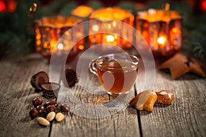 Homemade Christmas mulled wine punch with gingerbread, nuts and sweets on wooden rustic table.