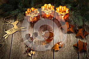 Homemade Christmas mulled wine punch with gingerbread, nuts and sweets on wooden rustic table.