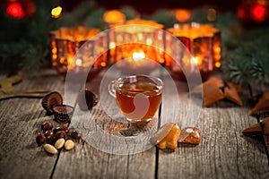 Homemade Christmas mulled wine punch with gingerbread, nuts and sweets on wooden rustic table.