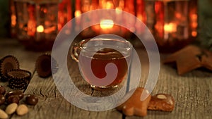 Homemade Christmas mulled wine punch with gingerbread, nuts and sweets on wooden rustic table in 4K VIDEO.