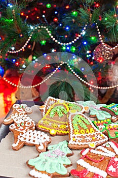 Homemade christmas tree shape gingerbread cookies on illuminated