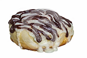 Homemade cinnabon cinnamon buns with cream cheese glaze and chocolate icing isolated on white background