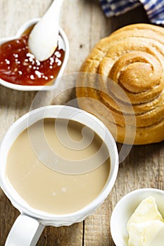 Homemade cinnamon roll served with butter and jam