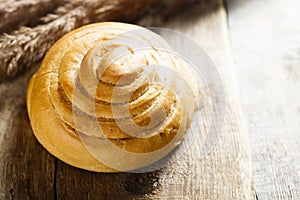 Homemade cinnamon roll on wooden desk