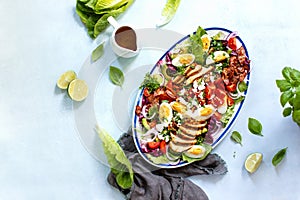 Homemade Cobb salad served in an oval dish