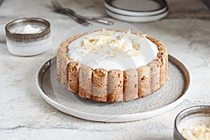 Homemade Coconut Buttermilk Pound Cake glazed whipped cream and coconut flakes