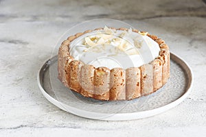 Homemade Coconut Buttermilk Pound Cake glazed whipped cream and coconut flakes