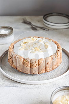 Homemade Coconut Buttermilk Pound Cake glazed whipped cream and coconut flakes