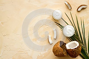Homemade coconut cream on beige background top-down frame copy space