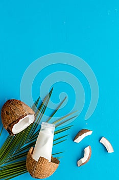 Homemade coconut cream on blue background top-down frame copy space