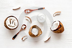 Homemade coconut cream - still life with spoon - on white wooden background top-down