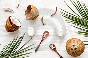 Homemade coconut cream - still life with spoon - on white wooden background top-down