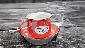 Homemade coffee in red enamel cup