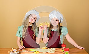 Homemade cookies best. Kids baking cookies together. Kids aprons and chef hats cooking. Family recipe. Culinary