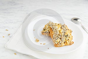 Homemade cookies with cereals and nuts on a marble table.