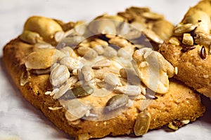 Homemade cookies with cereals and nuts on a marble table close up