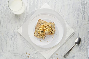 Homemade cookies with cereals and nuts with milk on a marble table.