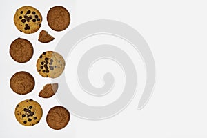 Homemade cookies with chocolate, nuts and coffee beans on a white background.