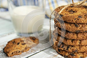 Homemade cookies with chocolate, nuts and milk on a wooden table and an art phone in the morning. Close up. Breakfast.