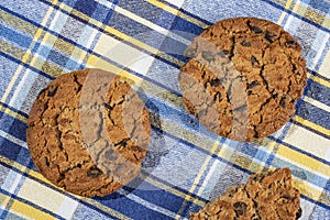 Homemade cookies with chocolate, nuts and milk on a wooden table and an art phone in the morning. Close up. Breakfast.