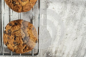 Homemade cookies with chocolate, nuts and milk on a wooden table and an art phone in the morning. Close up. Breakfast.