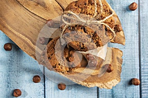 Homemade cookies with chocolate, nuts and milk on a wooden table and an art phone in the morning. Close up. Breakfast.